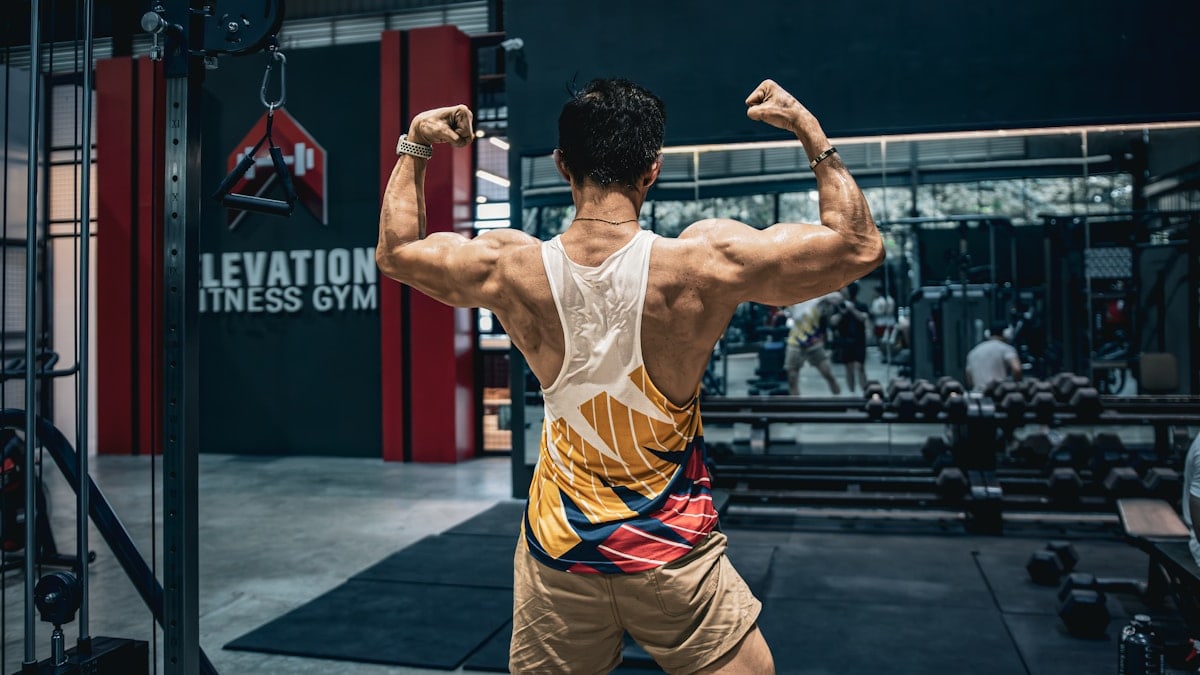 A man doing a back squat in a gym